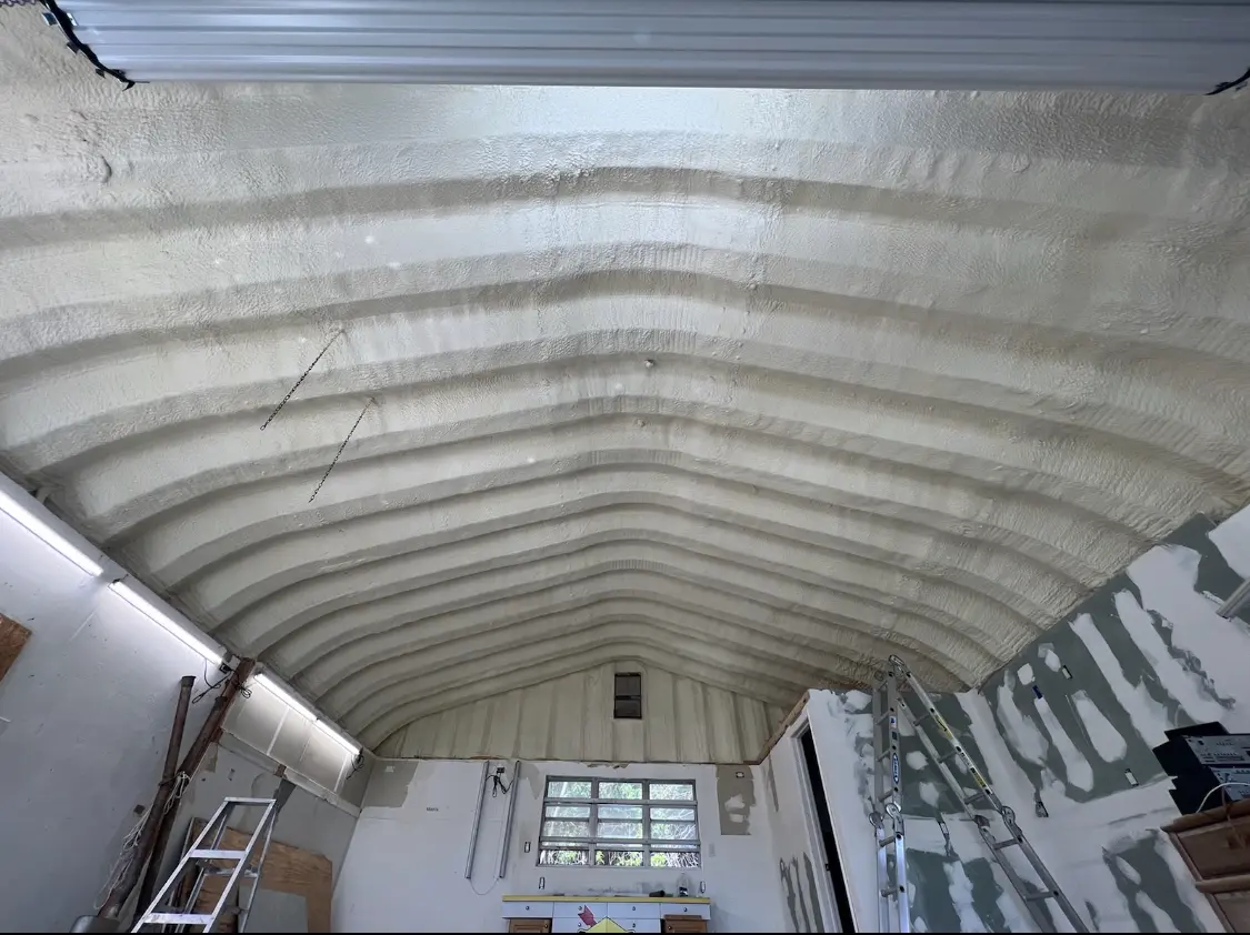 Spray polyurethane foam applied to the underside of a metal roof deck in North Elba